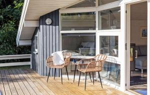a patio with a table and chairs on a deck at Stunning Home In Humble With Wifi in Humble