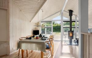 a dining room with a table and chairs and a fireplace at Stunning Home In Humble With Wifi in Humble