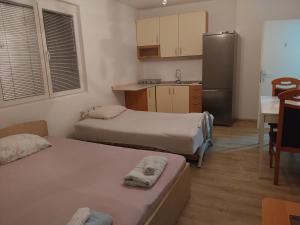 Katil atau katil-katil dalam bilik di Eli Apartments