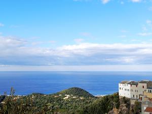 a building on top of a hill next to the ocean at vue mer in Farinole