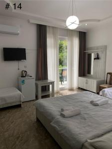 una camera da letto con un letto grande e una televisione di Rezo's House a Kvariati