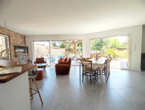 a living room with a table and chairs at Villa et Spa in Pornic
