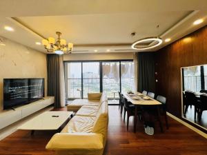 a living room with a couch and a dining room at Tami Homes - Vinhomes D'Capitale Executive Apartment in Hanoi