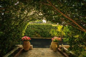 A garden outside Temenos Villa by Ortigiaapartments