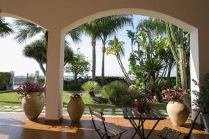 A garden outside Temenos Villa by Ortigiaapartments
