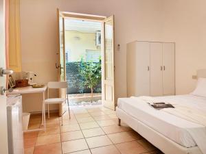 a bedroom with a bed and a table and a desk at Holihome Room Eight in Tortoreto Lido