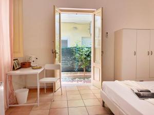 a bedroom with a bed and a table and a desk at Holihome Room Eight in Tortoreto Lido