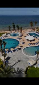 an aerial view of a resort with several swimming pools at Blue Bay Appart hôtel in Monastir