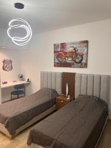 a bedroom with a bed and a motorcycle on the wall at Blue Bay Appart hôtel in Monastir +73 photos
