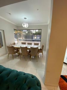 a dining room with a table and chairs at Goldman Florida Guesthouse in Roodepoort