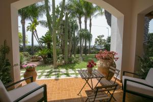 A garden outside Temenos Villa by Ortigiaapartments