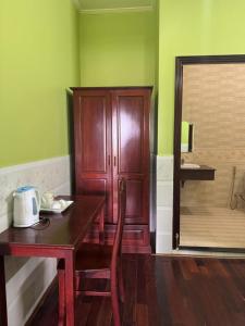 a room with a wooden table and a wooden cabinet at Hưng Thịnh 1 in Can Tho