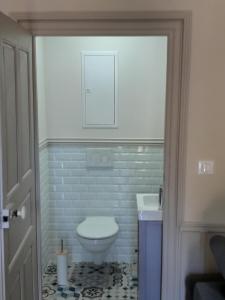a bathroom with a toilet and a sink at Les Bruneilles in Dracy-le-Fort