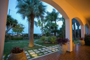 A garden outside Temenos Villa by Ortigiaapartments
