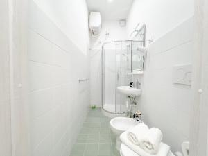 a white bathroom with a toilet and a sink at Elegante Suite a 50 mt dal Mare - Wifi - Centro in Arenzano
