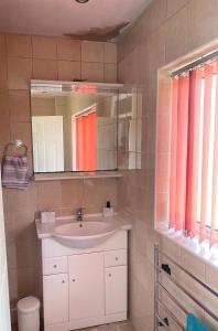 a bathroom with a sink and a mirror at Northern homestay between High Peak & Manchester in Hadfield
