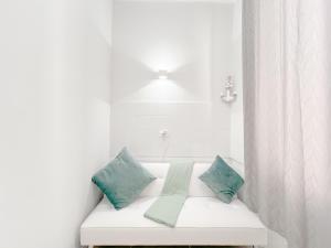 a white bench with pillows on it in a bathroom at Elegante Suite a 50 mt dal Mare - Wifi - Centro in Arenzano +7 photos