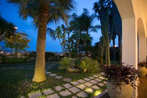 A garden outside Temenos Villa by Ortigiaapartments