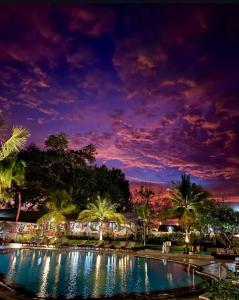 Una vista nocturna de una piscina en un resort. en Apt 6238 at Jayakarta Residence, en Seminyak