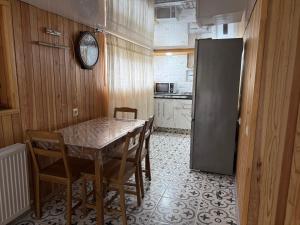 a kitchen with a table and chairs and a refrigerator at Family Holiday in K'obulet'i