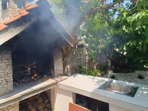 a fire is coming out of a brick oven at Apartman Čarija 2 in Trogir