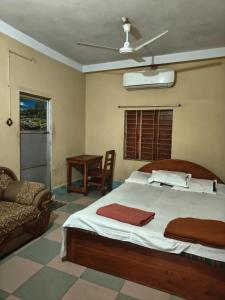 a bedroom with a large bed and a chair at City Abashik Hotel 