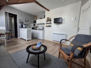 a living room with a couch and a table at Gîte 4 pers, Jacuzzi privatif & Piscine & Lit cabane in Saint-Georges-sur-Cher +11 photos