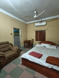 a bedroom with a large bed and a couch at City Abashik Hotel 
