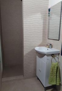 a bathroom with a sink and a shower at Tündérkert vendégház  +74 photos