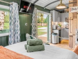 a kitchen with green walls and a table with green towels at The Train Carriage in NWI