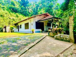 a small house in the middle of a forest at DK Paddy Field Villa in Unawatuna in Unawatuna