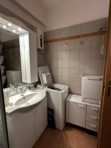 a small bathroom with a sink and a mirror at Saronida Beachwalk Stay in Saronida