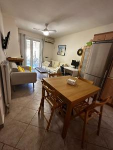 a living room with a table and a couch at Saronida Beachwalk Stay in Saronida +5 photos