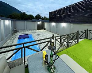 a balcony with a swimming pool on a house at A frame with mountain view in Xanlar