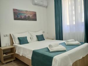 a bedroom with two beds with towels on them at Vila Lorena in Mangalia +11 photos