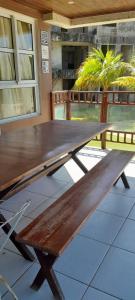 a wooden picnic table sitting on a patio at Golden Dunas 123B in Extremóz