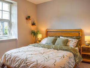 ein Schlafzimmer mit einem großen Bett mit zwei Lampen in der Unterkunft Yorkshire Cottage in Clayton West