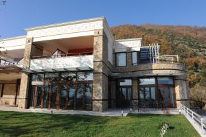 a house on the side of a mountain at Agapi Luxury Hotel in Kato Loutraki