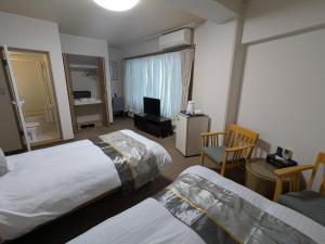 Llit o llits en una habitació de 富士たから荘 旭日館