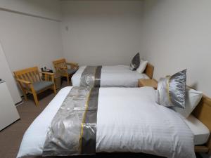 Llit o llits en una habitació de 富士たから荘 旭日館