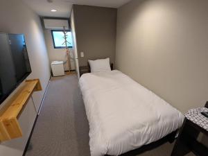Llit o llits en una habitació de 富士たから荘 旭日館 28 fotos més