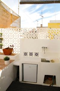 a balcony with a white counter and a sink at Casa Alma Lusa - Olhão center - 2 bedrooms in Olhão