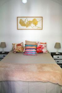 a bedroom with a large bed with pillows on it at Casa Alma Lusa - Olhão center - 2 bedrooms in Olhão +52 photos