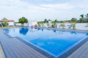 a swimming pool in a villa with blue water at US Cabanas in Nilaveli