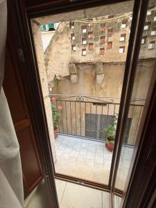 a view from a window of a balcony with plants at La Casetta in Ischitella