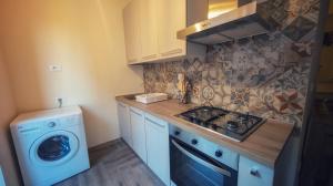 a kitchen with a washing machine and a washer at Conca D'Oro Guest House - Elisabetta in Rome
