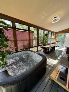 a large hot tub in a room with a pool table at Waterfront Zen-Dock, Paddleboards, Jacuzzi & Games in Saint Augustine