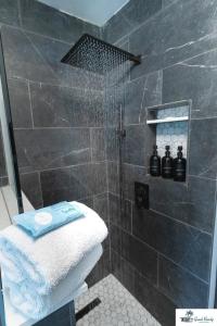 a bathroom with a shower with a towel on a toilet at Waterfront Zen-Dock, Paddleboards, Jacuzzi & Games in Saint Augustine +71 photos