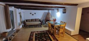 a living room with a table and a couch at Casuta din Deal in Vaideeni