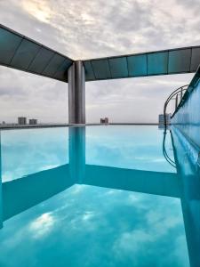 a swimming pool on the roof of a building at Vinia Studio for 3Pax in Manila +14 photos